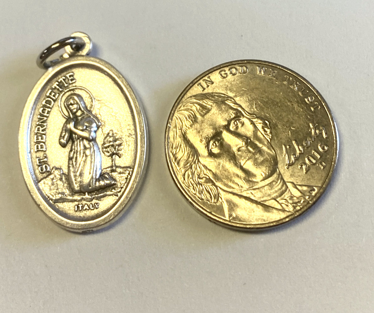 Small dual-sided St. Bernadette and Our Lady of Lourdes medal by Bob and Penny Lord, featuring religious imagery and intricate design.
