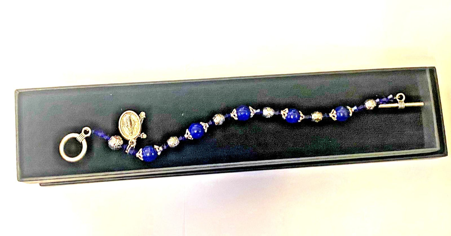 Miraculous Medal sapphire Madonna del Parto bracelet featuring religious jewelry with a silver medal and sapphire accents.