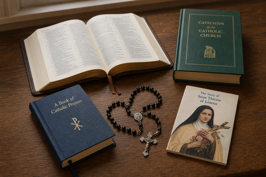 Open Bible, prayer book, rosary, and Catholic books on a wooden table