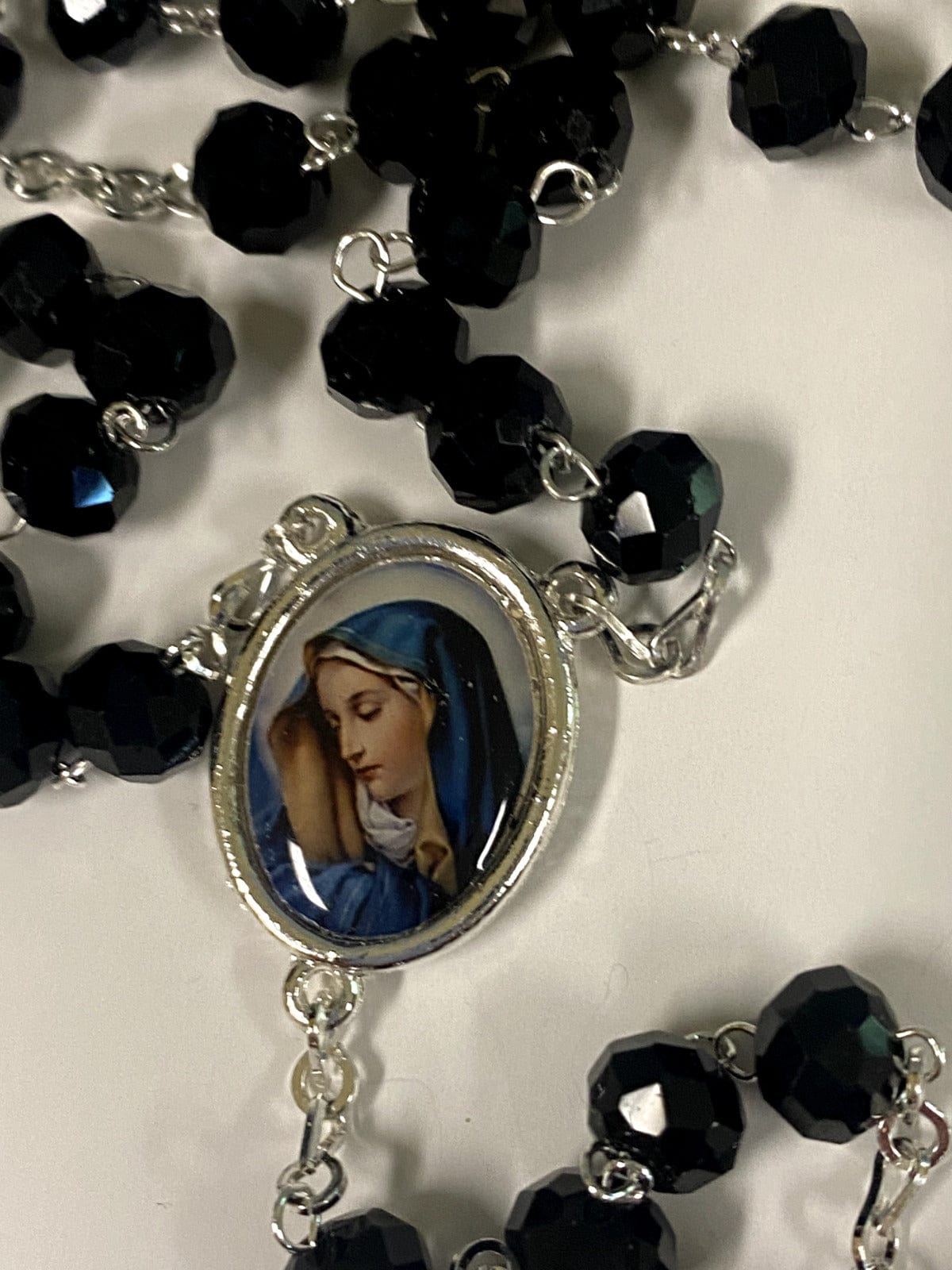 Black handmade Blessed Mother rosary with beads and crucifix, crafted in Colombia by Bob and Penny Lord for Christian devotion.