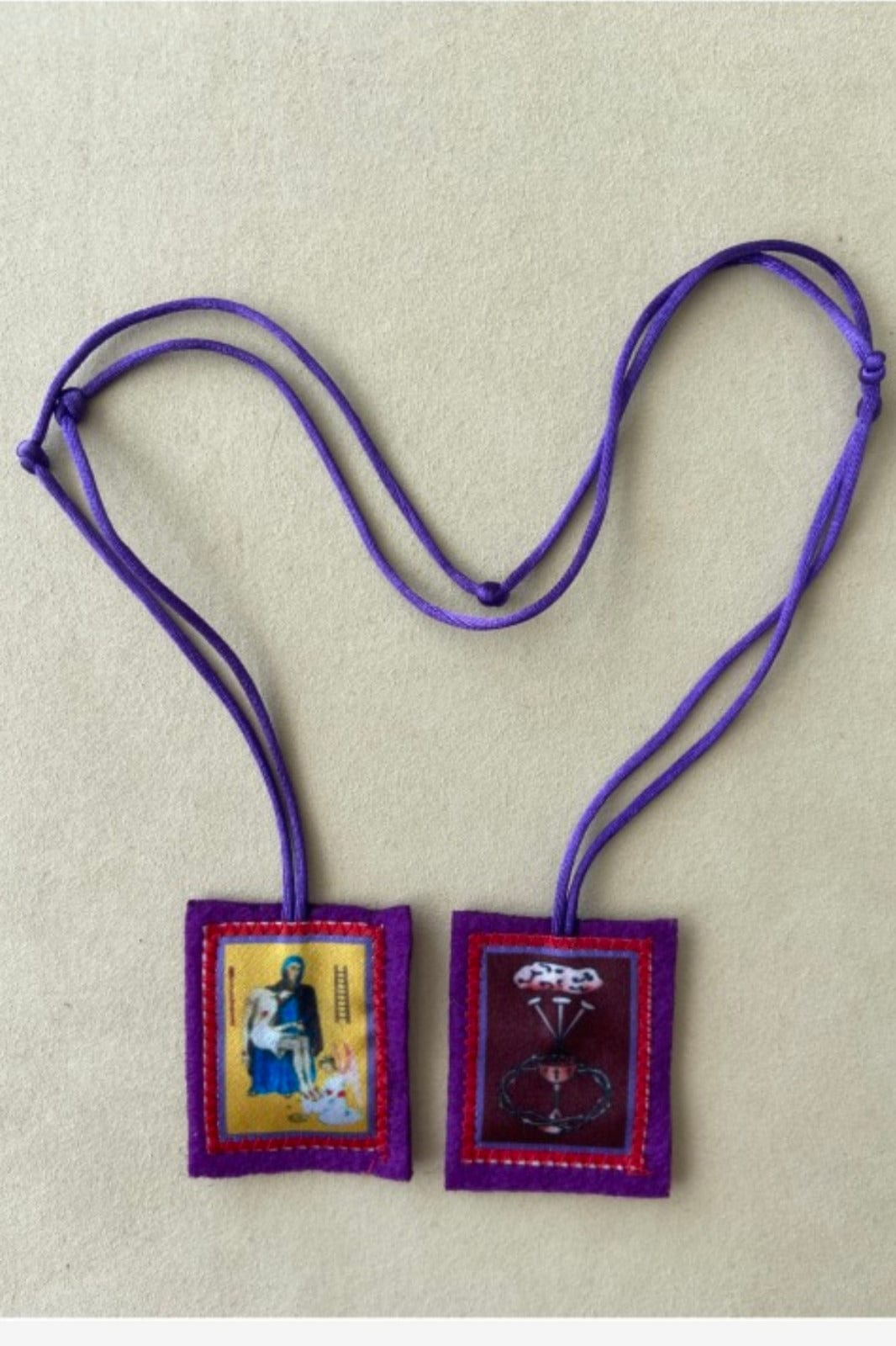 Handmade purple scapular from Colombia by Bob and Penny Lord, featuring detailed fabric craftsmanship.