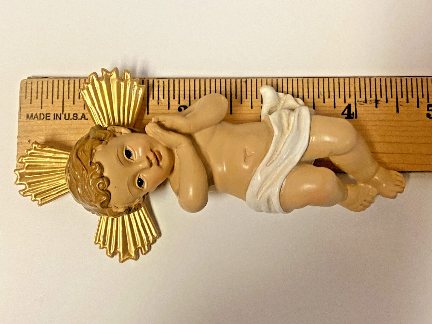 Baby Jesus in a 5-inch nativity manger statue by Bob and Penny Lord, detailed religious Christian collectible figure.