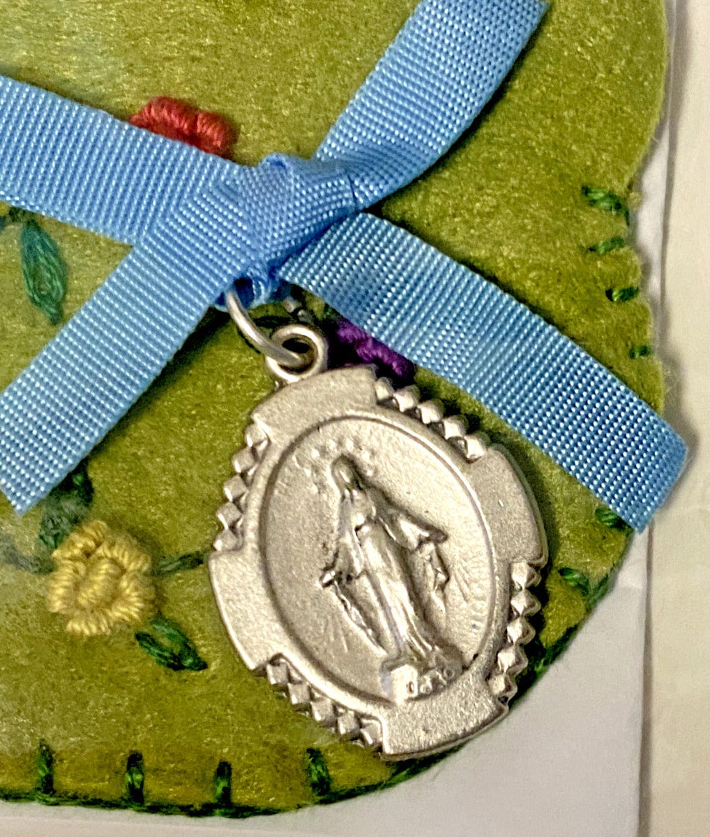 Silver tone Our Lady of the Miraculous Medal jewelry collectible from Japan, featuring religious Christian symbolism.
