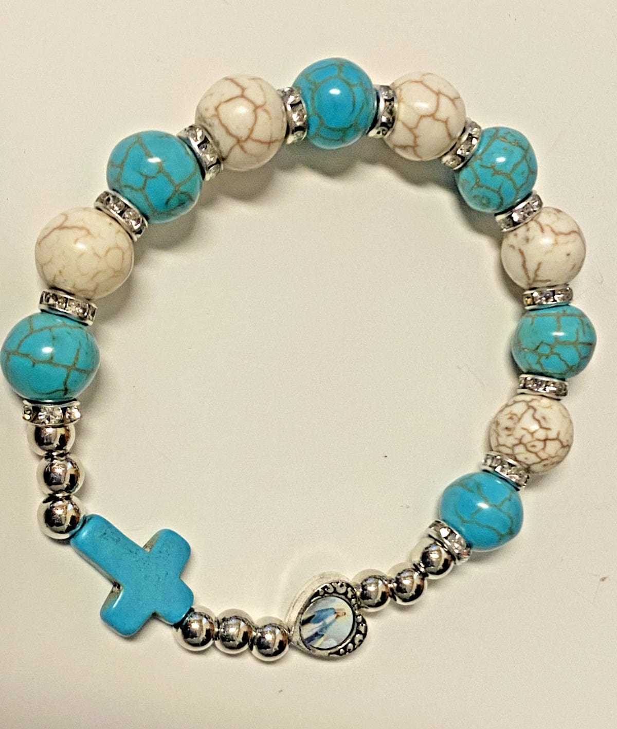 Blue and white beaded stretch bracelet with Miraculous Medal, Christian jewelry by Bob and Penny Lord, featuring religious and spiritual design.