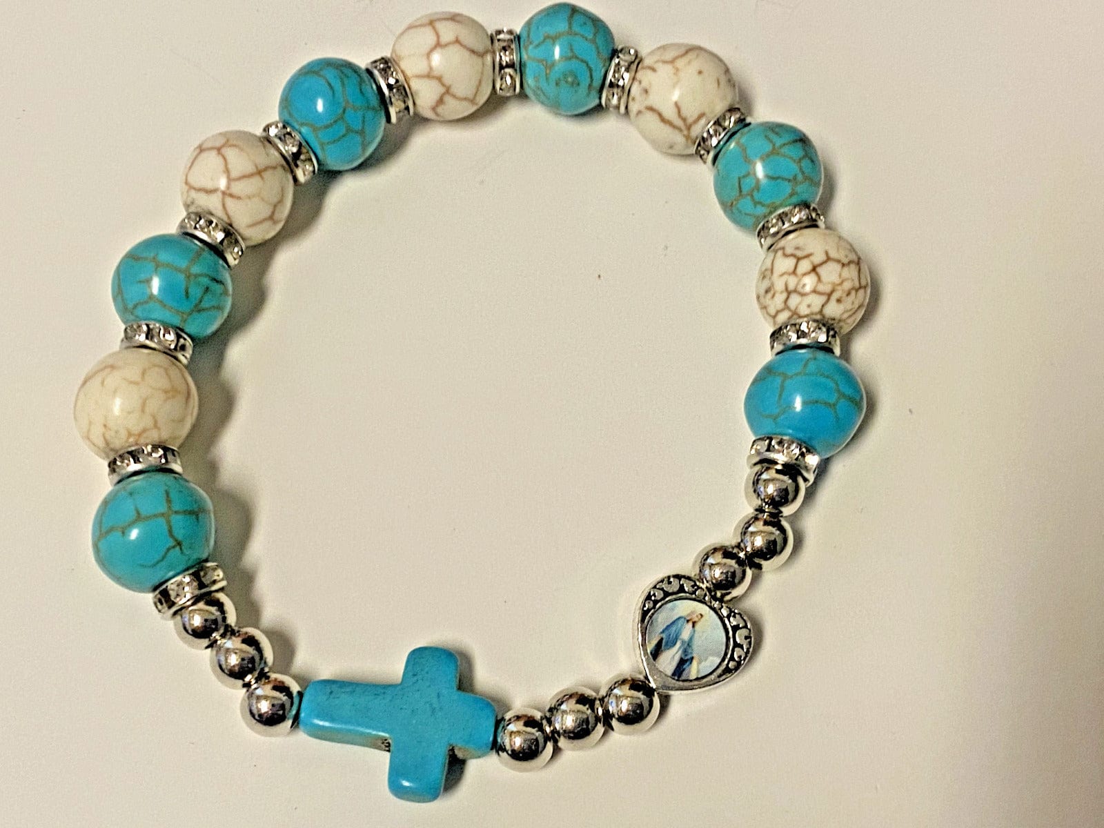 Blue and white bead stretch bracelet with Miraculous Medal, Christian jewelry by Bob and Penny Lord, from Japan.