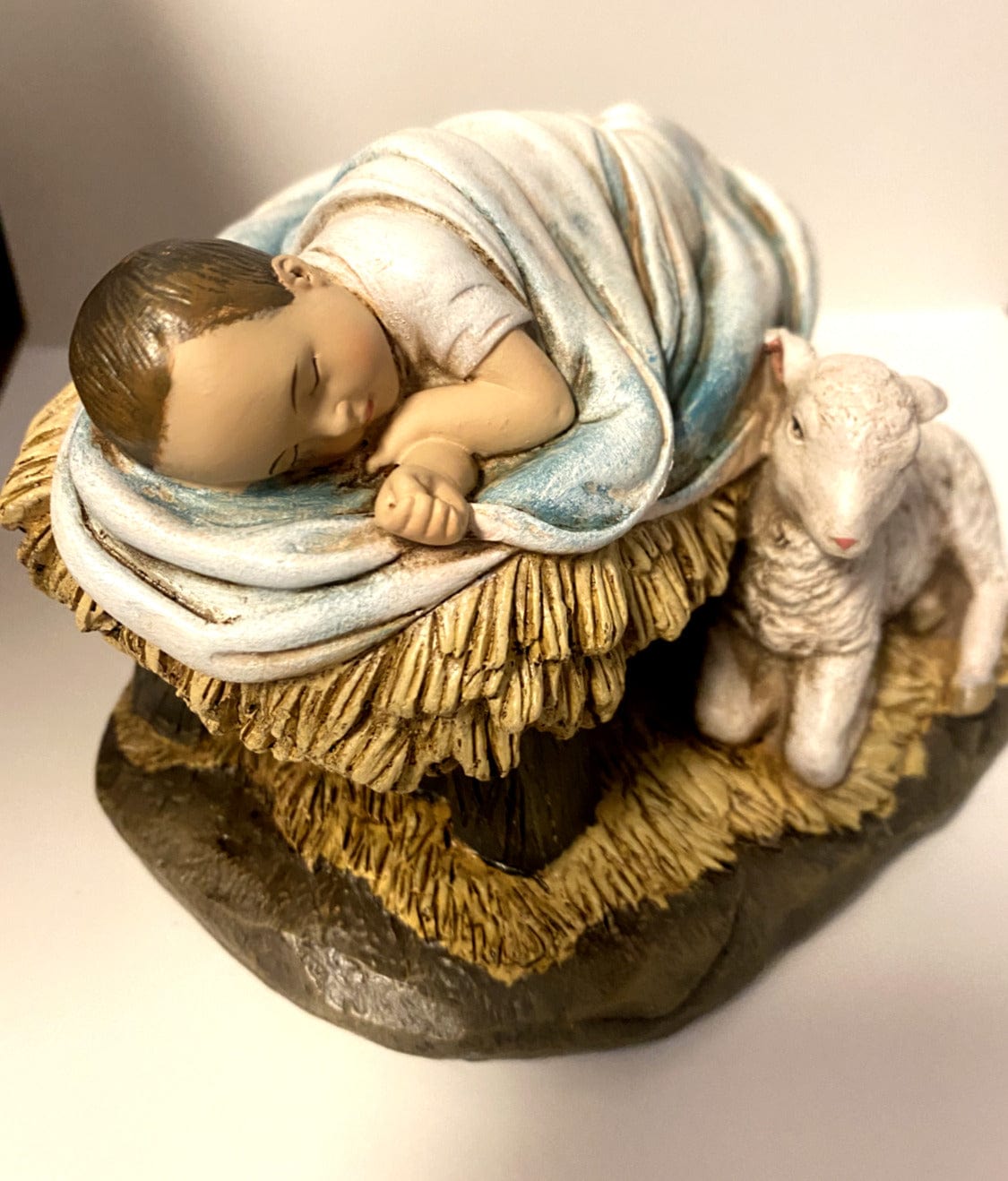 Sleeping Baby Jesus with Lamb figurine by Bob and Penny Lord, depicting a peaceful Christian religious statue.