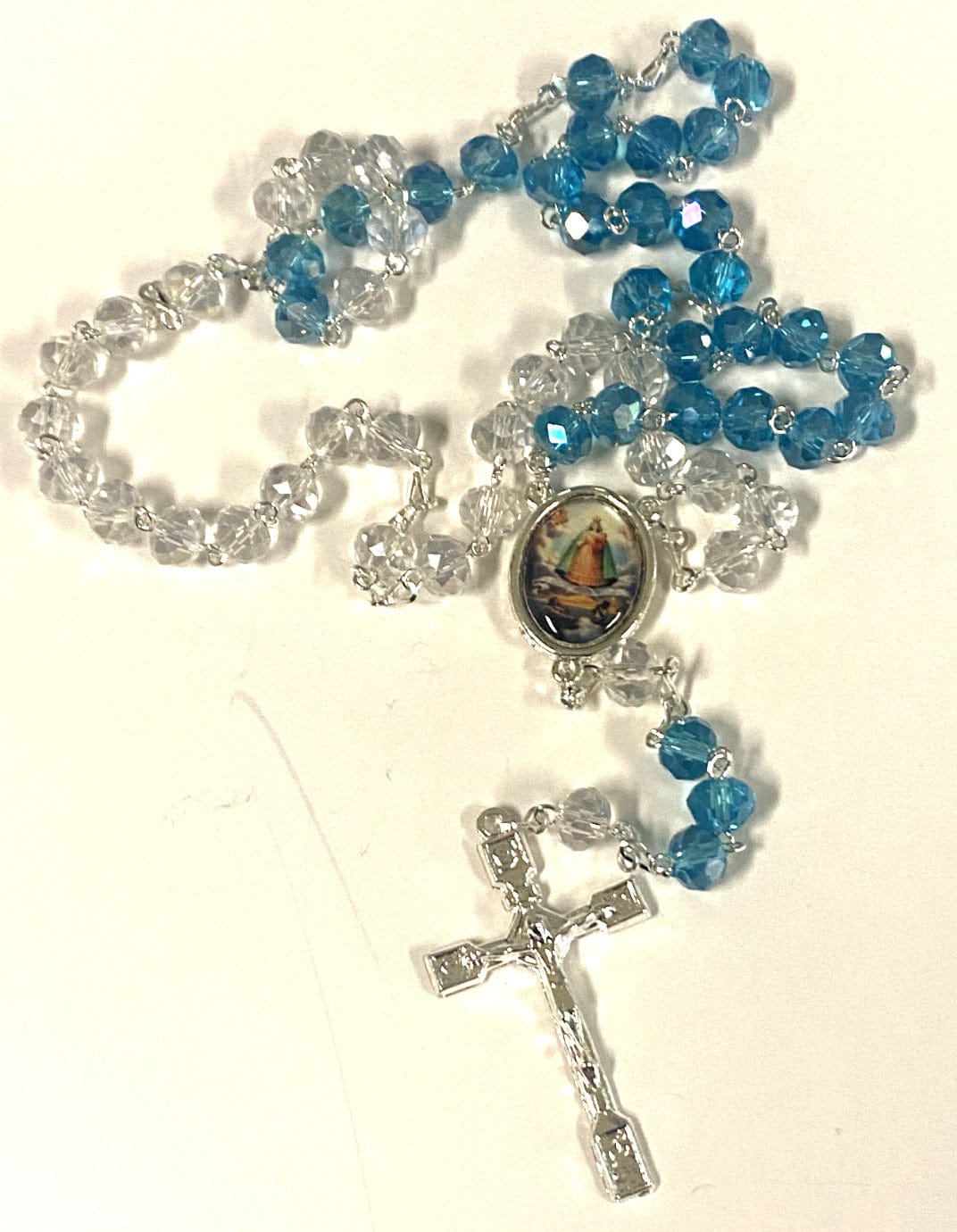 Handmade Our Lady of Charity rosary with beads and crucifix, crafted in Colombia by Bob and Penny Lord, used for prayer and devotion.