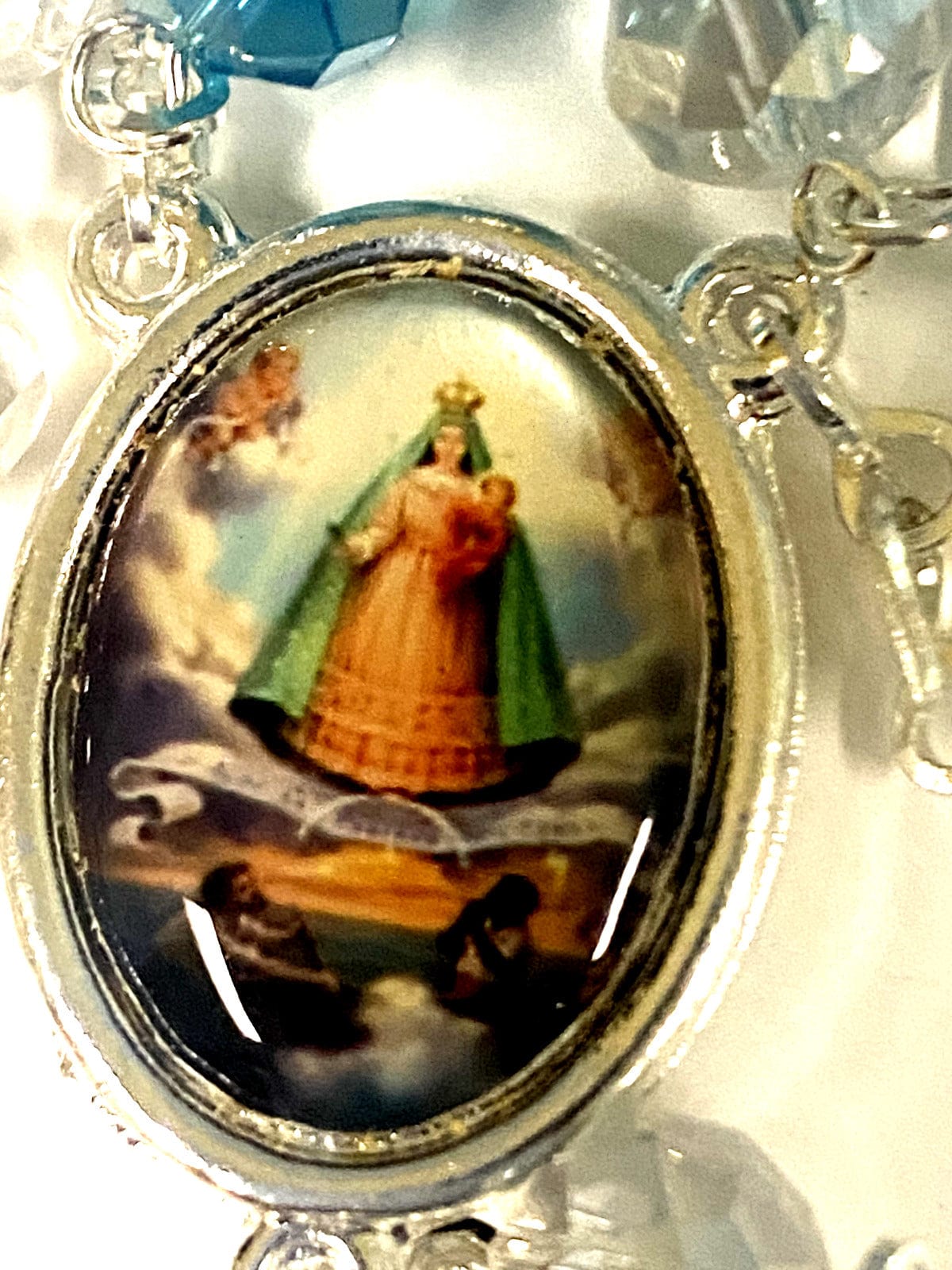 Handmade Our Lady of Charity rosary from Colombia with beads and religious centerpiece, crafted by Bob and Penny Lord.