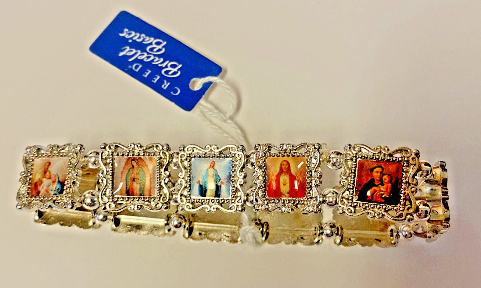 Silver bracelet with 11 saint charms from Bob and Penny Lord, Christian religious jewelry, collectible spiritual accessory.