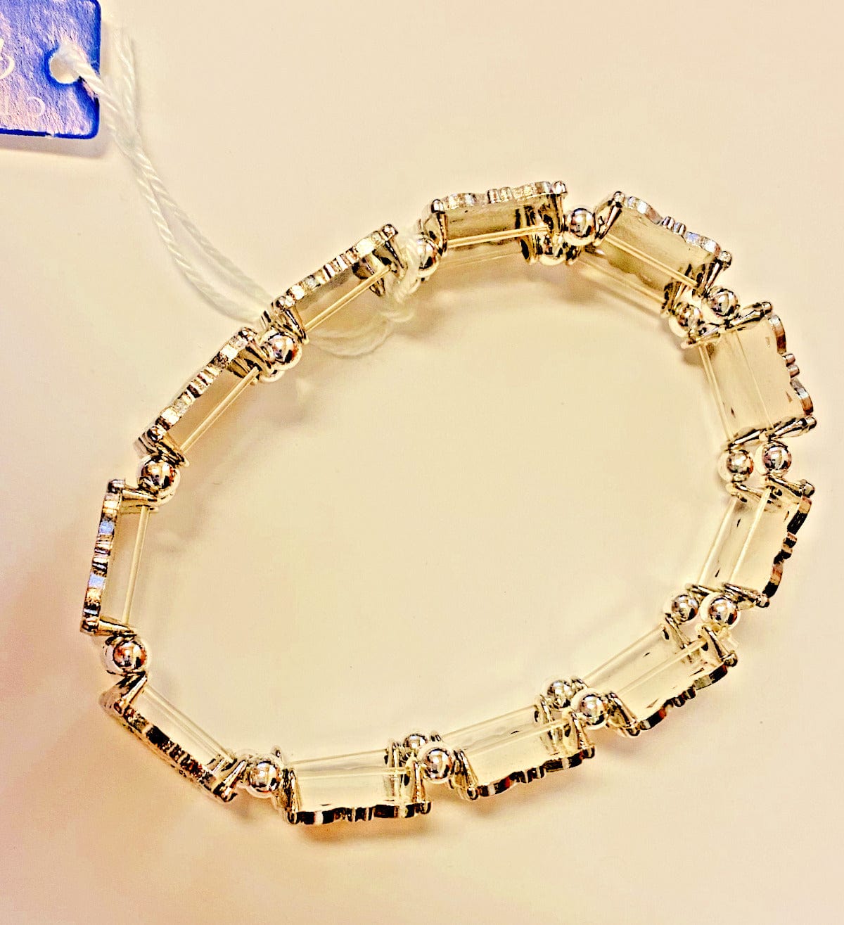 Silver bracelet featuring 11 saints charms, Christian jewelry by Bob and Penny Lord, with detailed saint illustrations.