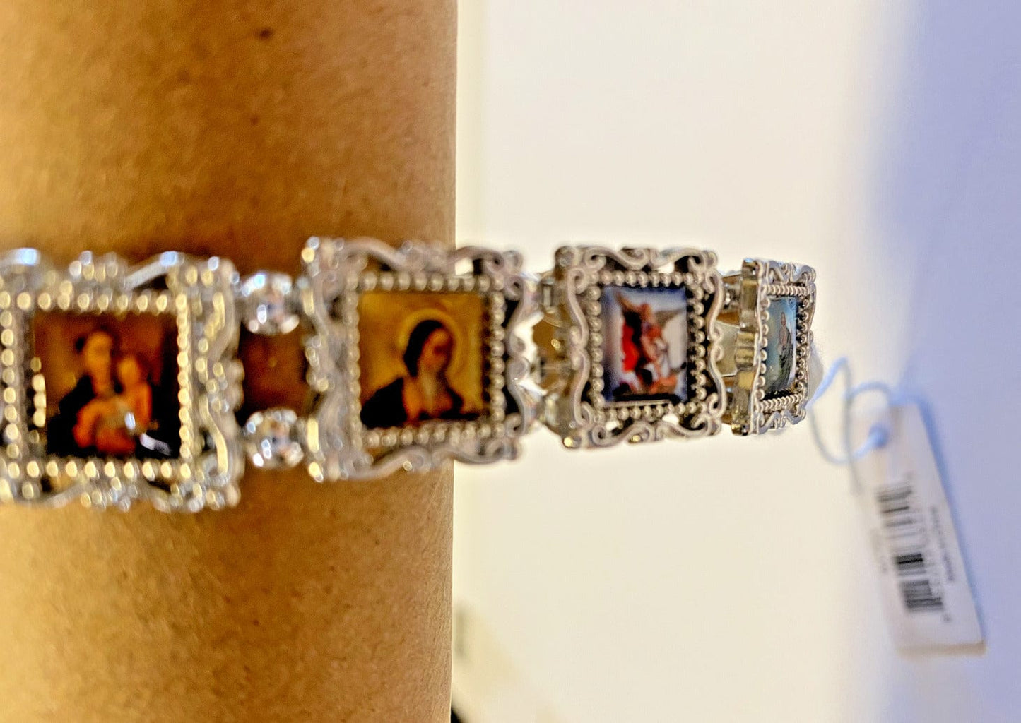 Silver Christian bracelet with 11 saints charms, featuring detailed religious jewelry by Bob and Penny Lord.