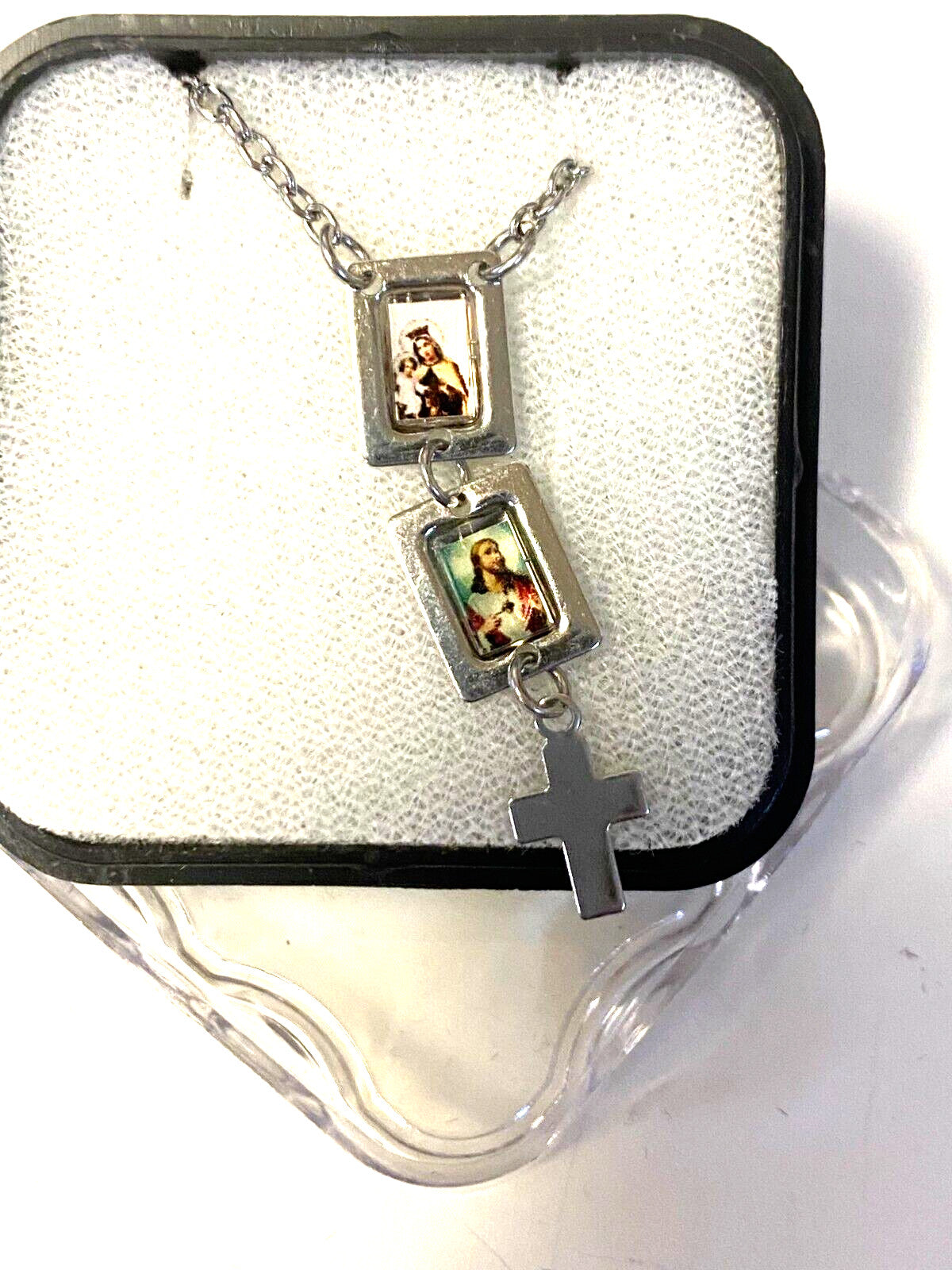 Tiny silver Sacred Heart and O L of Mount Carmel scapular collectible featuring religious imagery, crafted by Bob and Penny Lord.