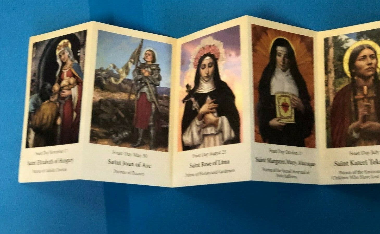 Saints for Girls Prayer Pocket Folder by Bob and Penny Lord featuring holy cards with religious imagery and Christian symbols.