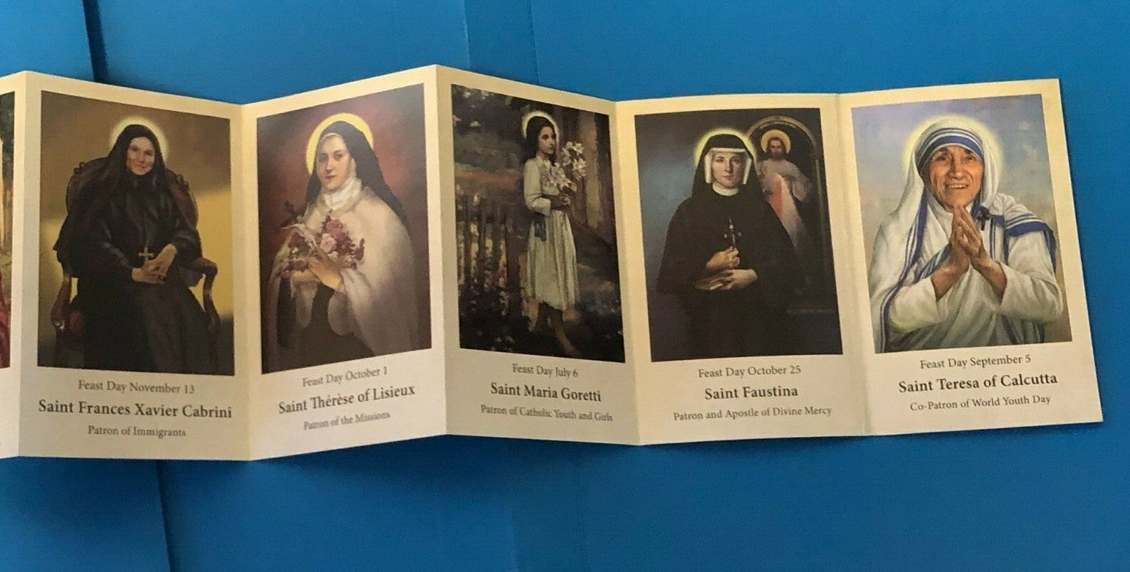Saints for Girls prayer pocket folder featuring Christian holy cards from Bob and Penny Lord, with colorful religious illustrations.