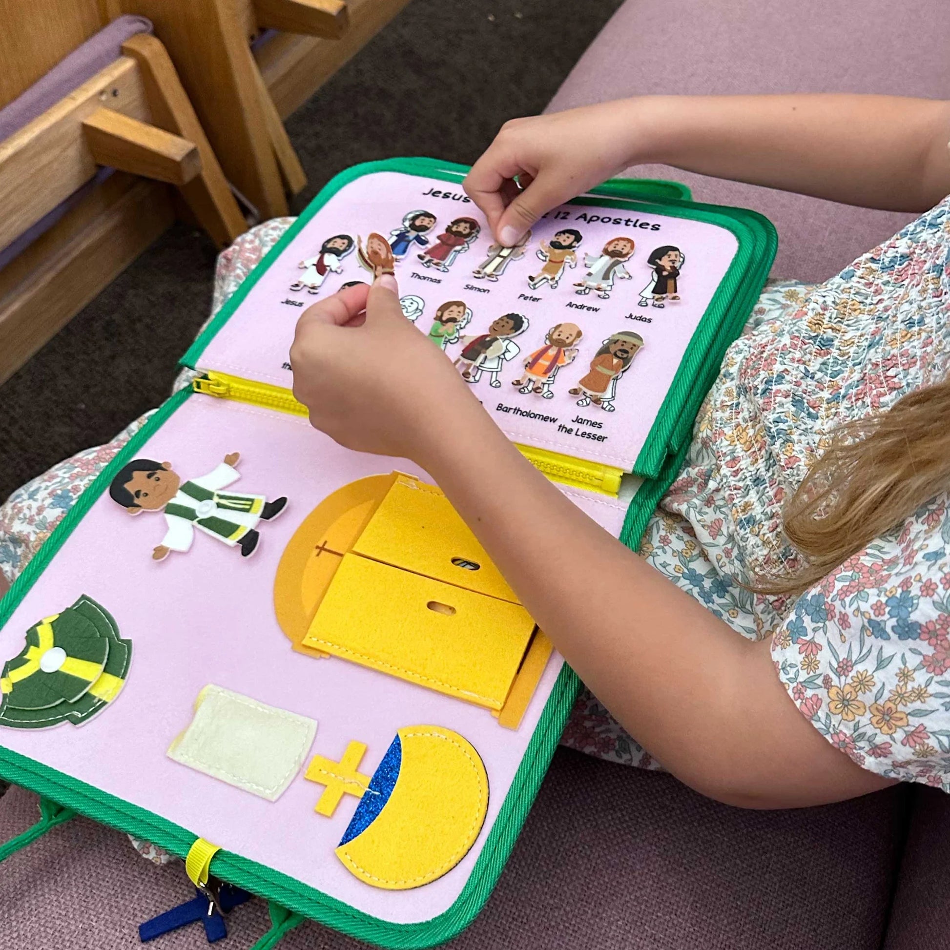 Brother Francis My Pray and Play Busy Book, a quiet felt toy with colorful religious scenes for children’s play and learning.