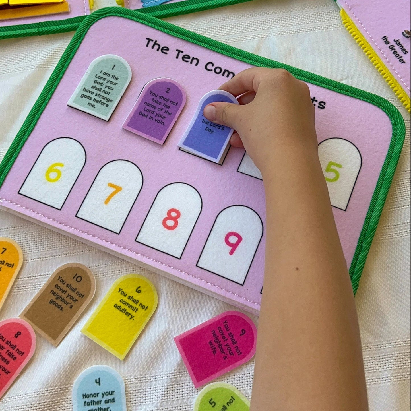 Brother Francis My Pray and Play Busy Book, a colorful felt quiet book with religious scenes and interactive pages for children.