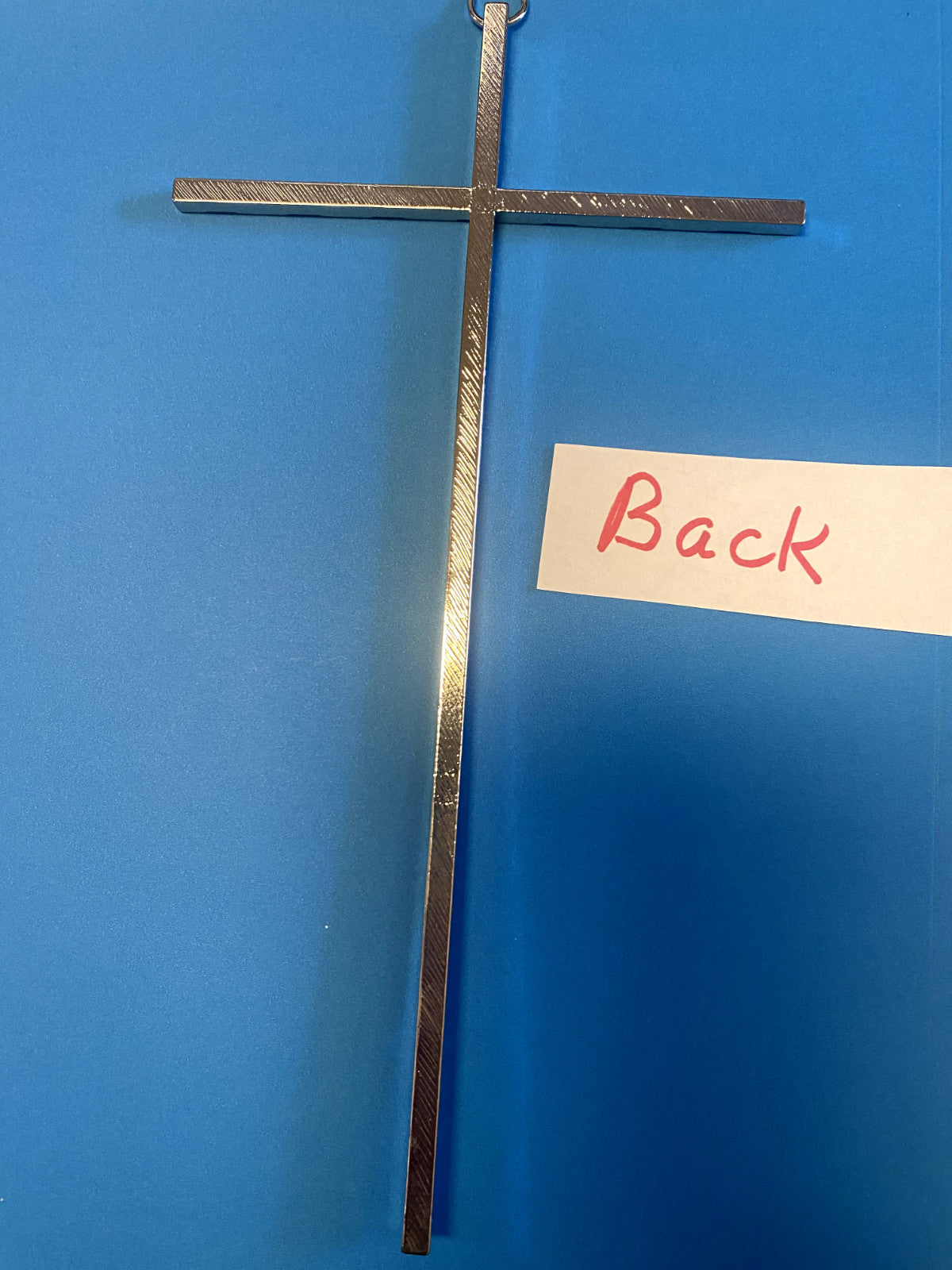 Silver tone hammered wall cross with textured surface, Christian collectible from Bob and Penny Lord for religious or spiritual decor.