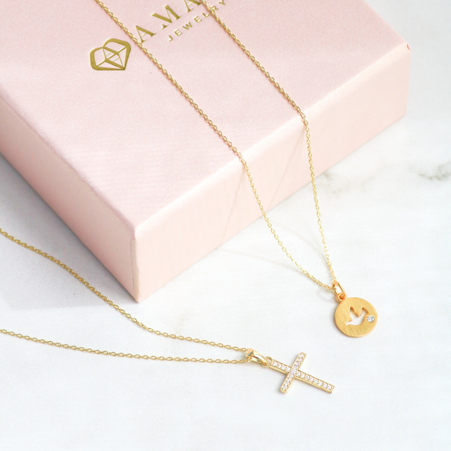 Gold vermeil and sterling silver cross necklace by AMADI Jewelry, featuring a delicate chain and detailed cross pendant.