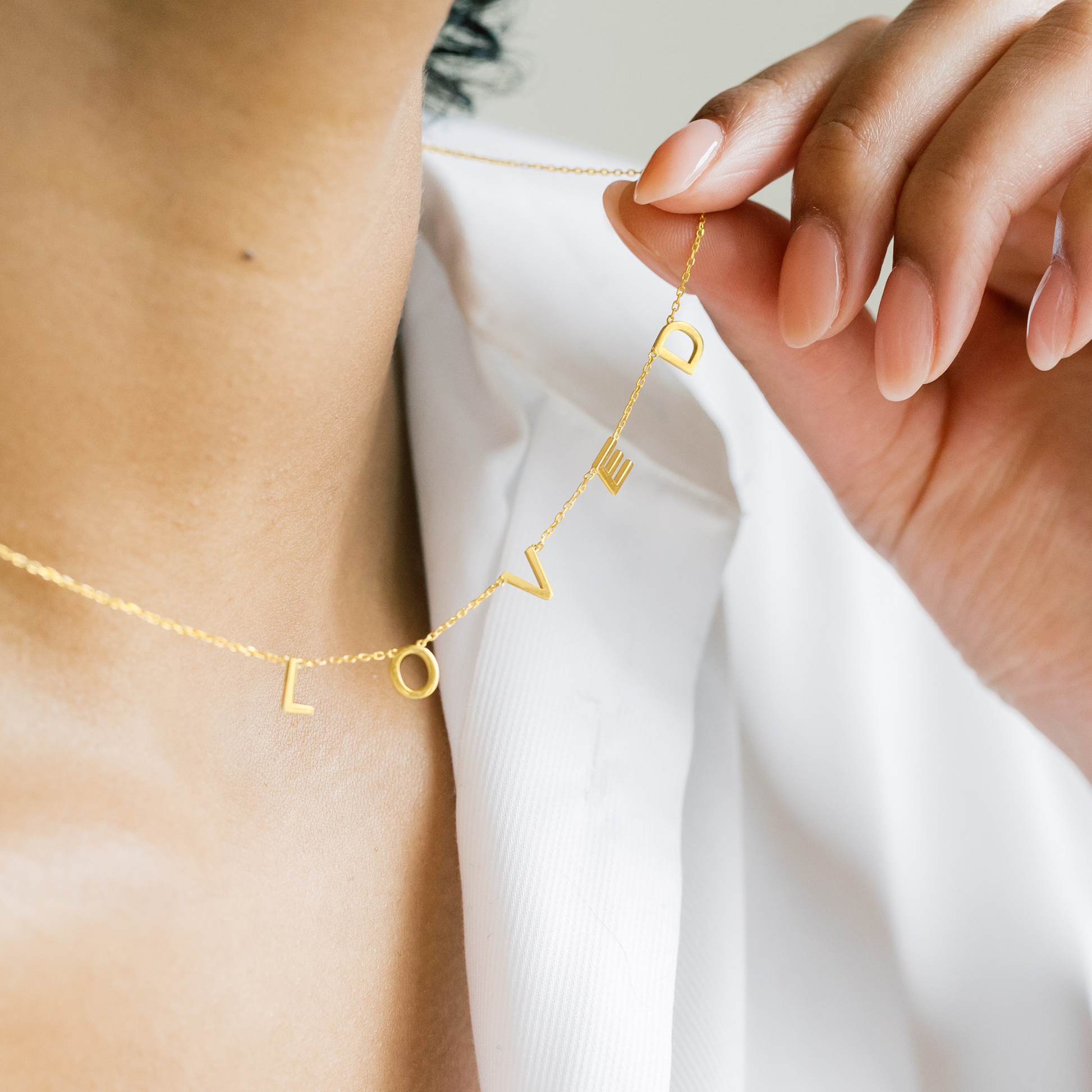 Gold-filled and sterling silver LOVED necklace by AMADI Jewelry featuring a delicate chain and heart pendant.