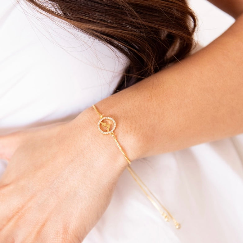 Adjustable Faith Moves Mountains bracelet by AMADI Jewelry in gold and silver with engraved inspirational message.