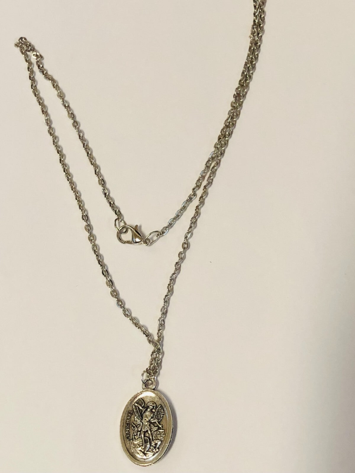 Two-sided Saint Michael the Archangel guardian angel medal necklace featuring detailed religious jewelry design.