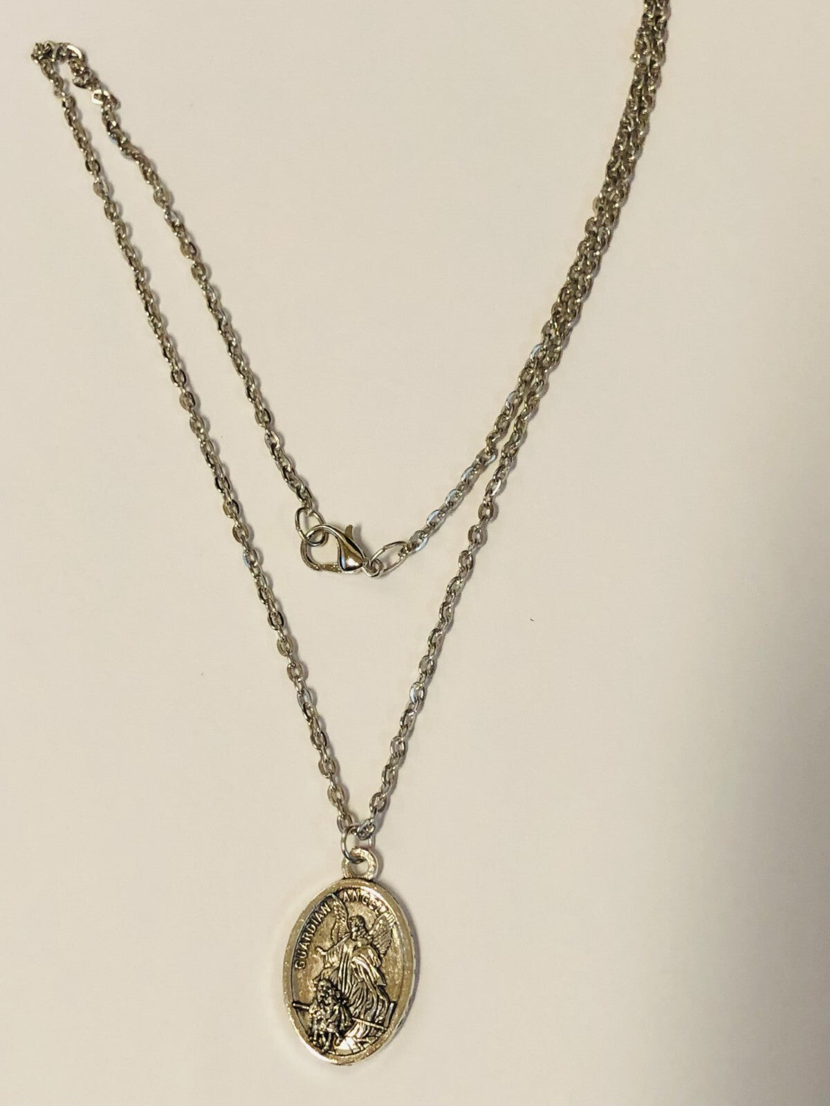 Two-sided Saint Michael the Archangel guardian angel medal necklace, unbranded fashion jewelry with detailed religious pendant.