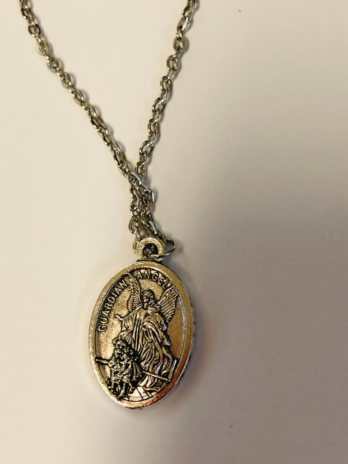 Two-sided Saint Michael the Archangel guardian angel medal necklace, unbranded fashion jewelry pendant with detailed religious design.