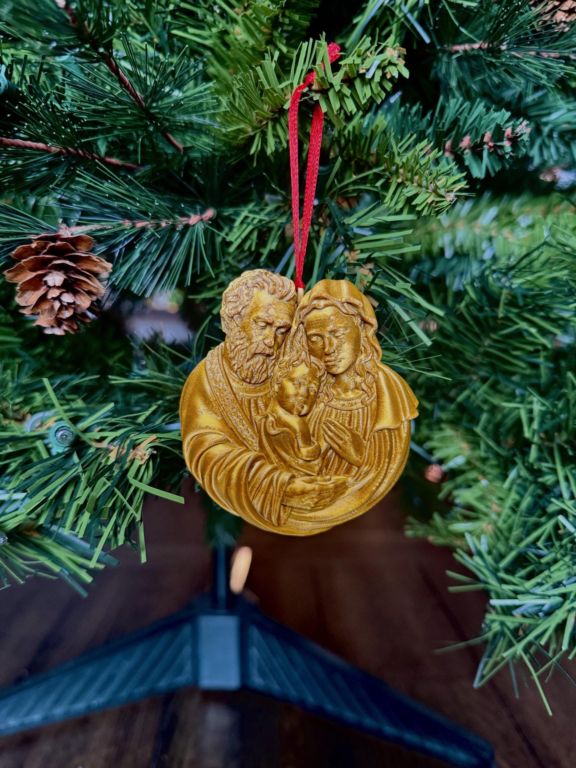 Holy Family Christmas ornament by St. Augustine Prints, featuring detailed depiction of the nativity scene with Mary, Joseph, and baby Jesus.