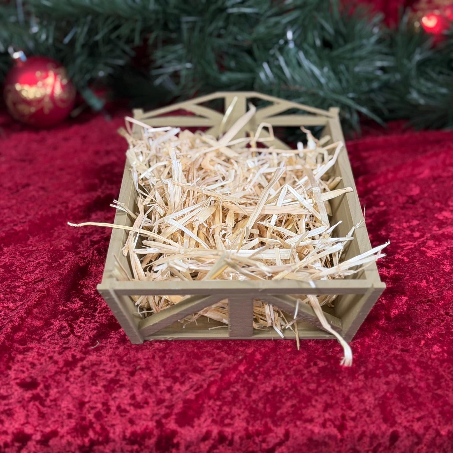 Nativity manger scene with figures of Mary, Joseph, baby Jesus, and animals, styled by St. Augustine Prints.