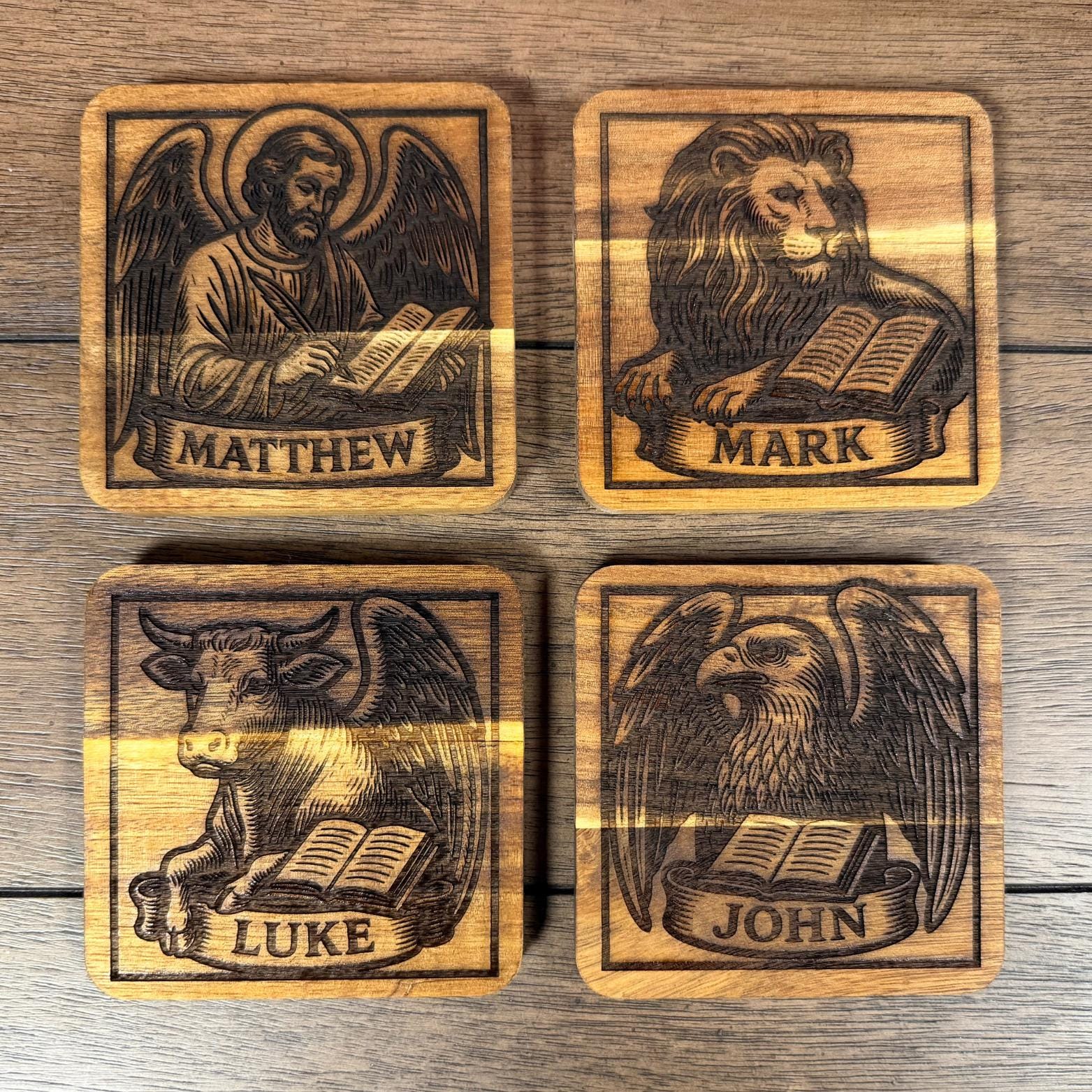 Wooden evangelist coaster set with religious Christian symbols, handcrafted by St. Augustine Prints.