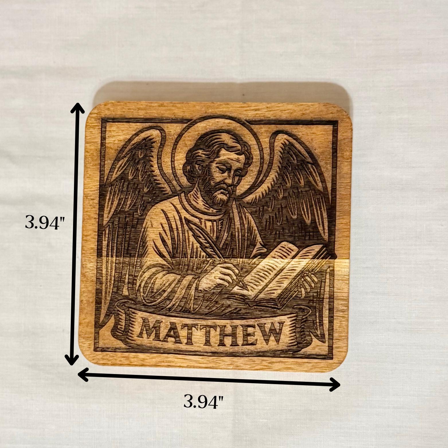 Set of wooden evangelist coasters with religious Christian artwork from St. Augustine Prints, featuring intricate engraved designs.