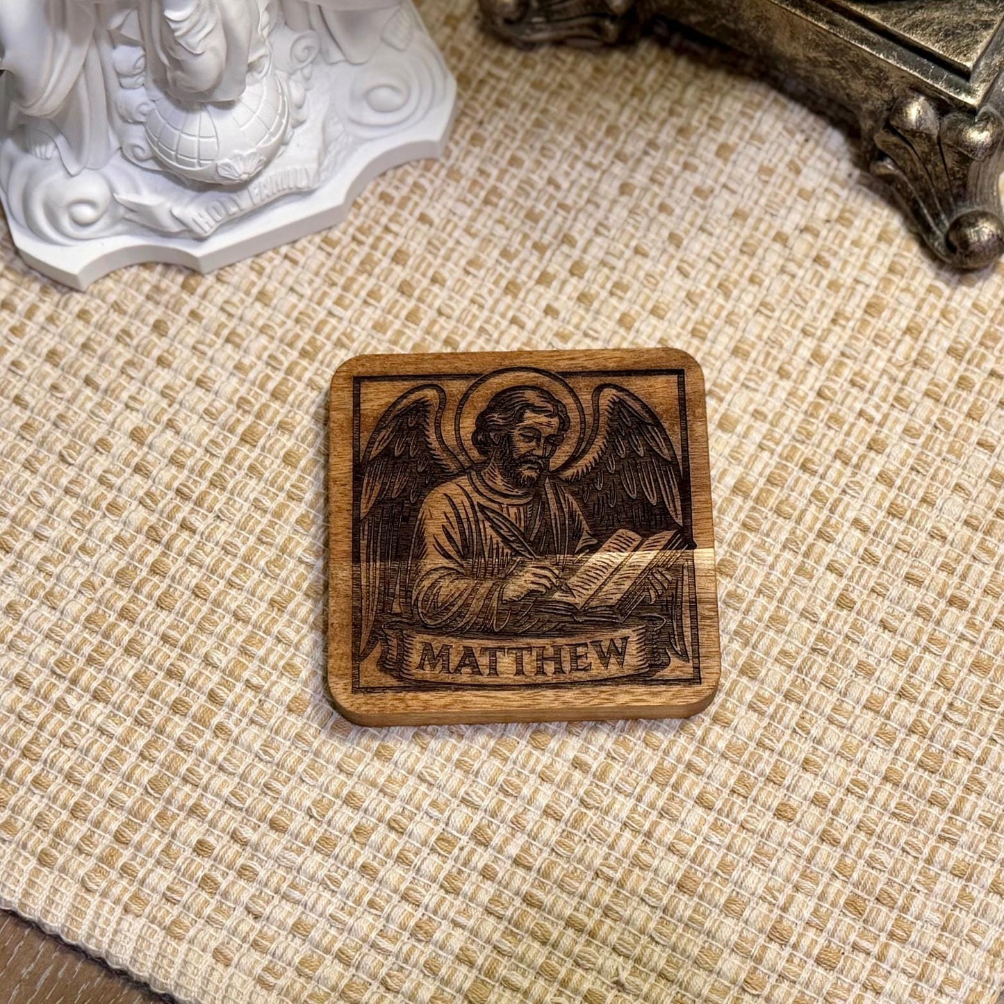 Set of wooden evangelist coasters with religious Christian design, featuring natural wood finish and Saint Augustine Prints branding.
