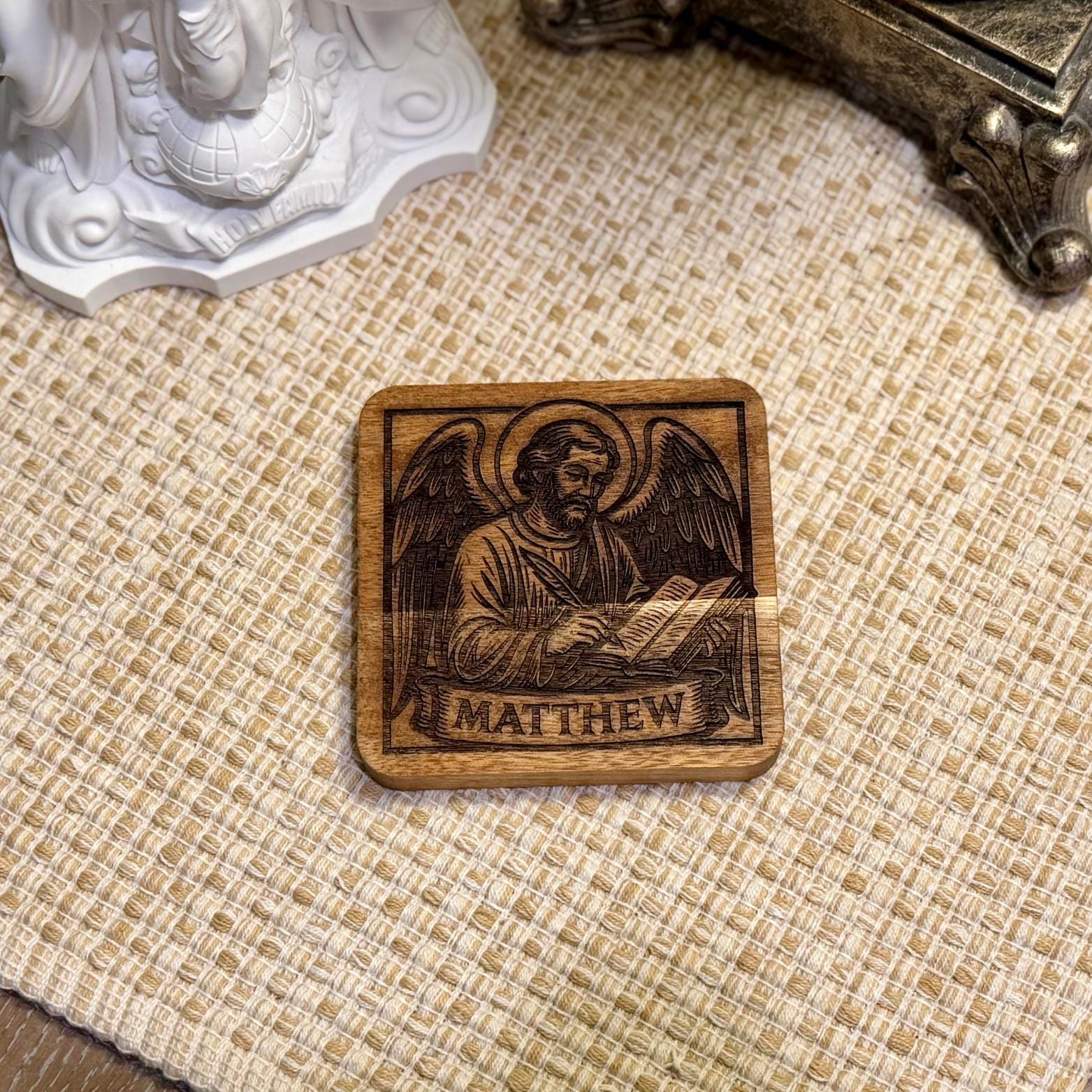 Set of wooden evangelist coasters with religious Christian design, featuring natural wood finish and Saint Augustine Prints branding.
