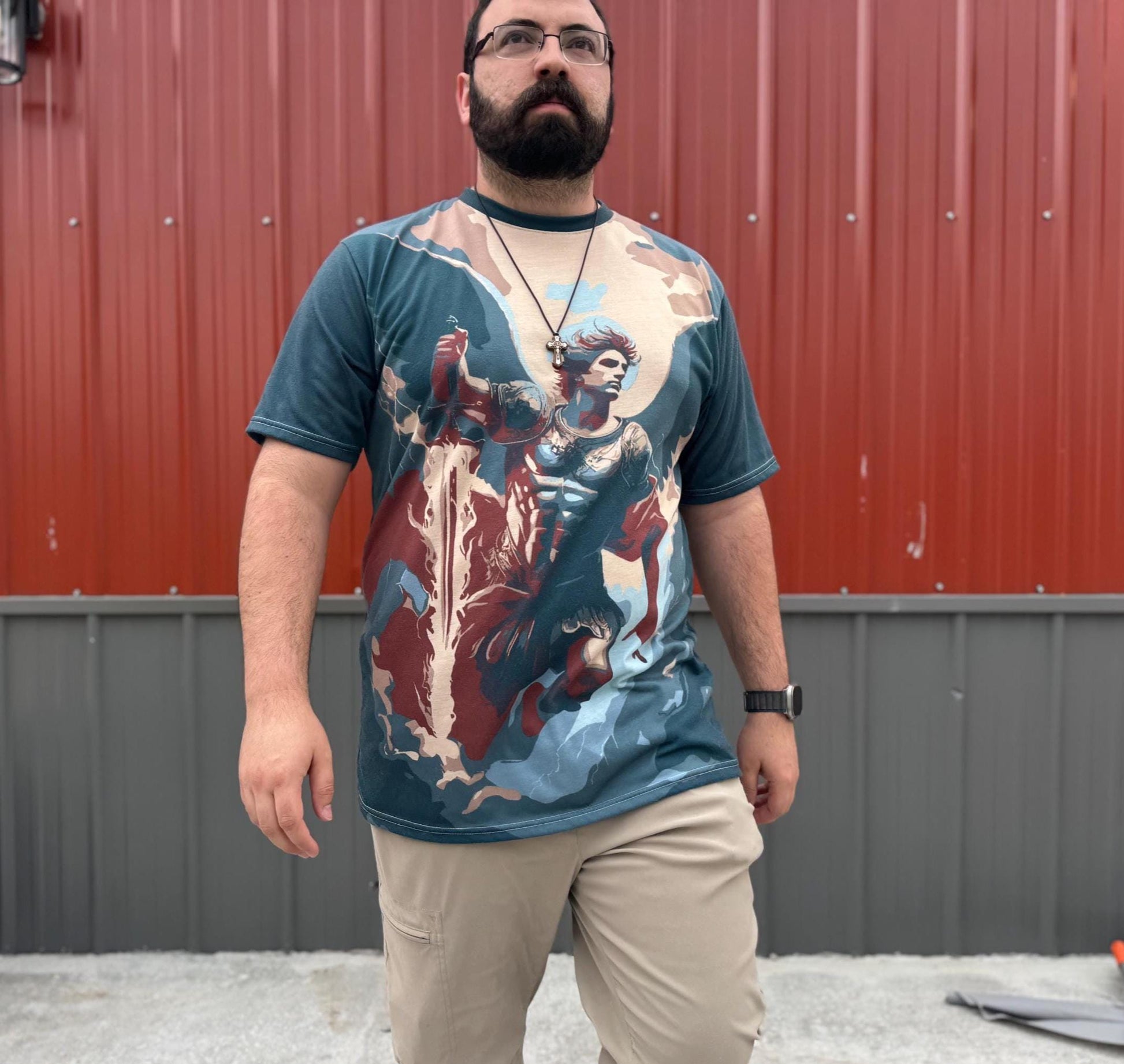 Saint Michael T-shirt by St. Augustine Prints featuring a detailed graphic of Saint Michael in armor on a white fabric shirt.