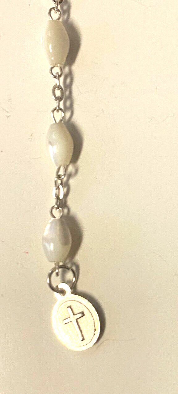 Infant of Prague charm on a decade rosary bracelet, religious jewelry by Bob and Penny Lord, featuring detailed spiritual design.