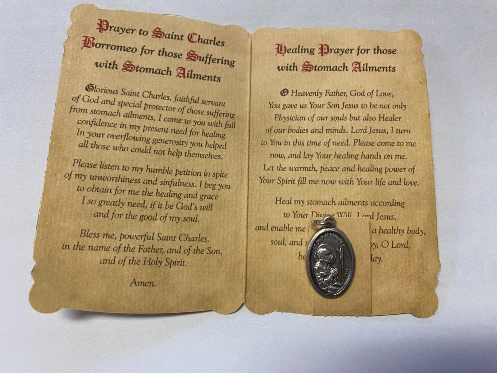 Saint Charles Borromeo prayer card and medal set, Christian religious collectibles by Bob and Penny Lord, featuring detailed imagery.