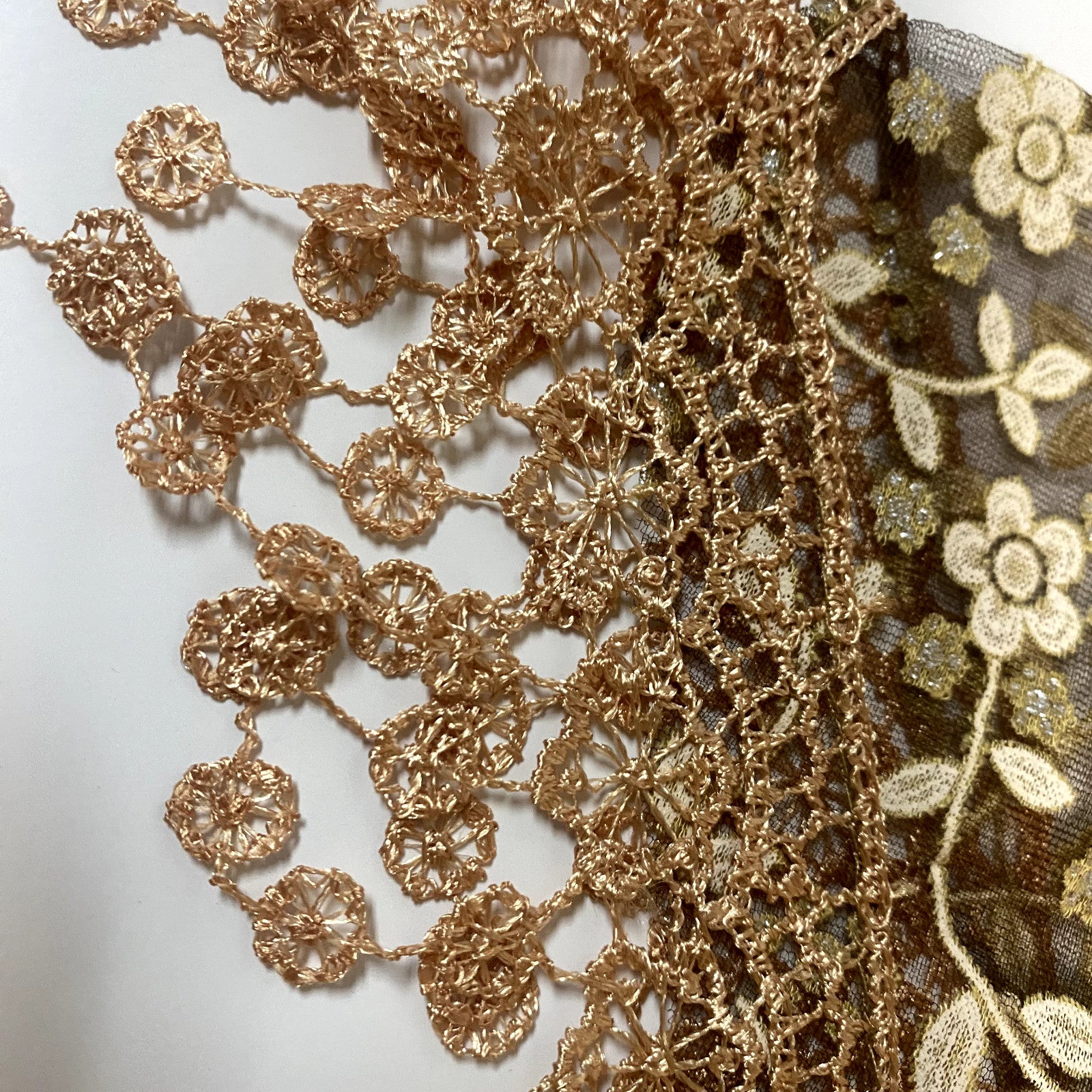 Women's brown lace church veil with intricate lace details, draped over a neutral background, showcasing elegant head covering accessory.
