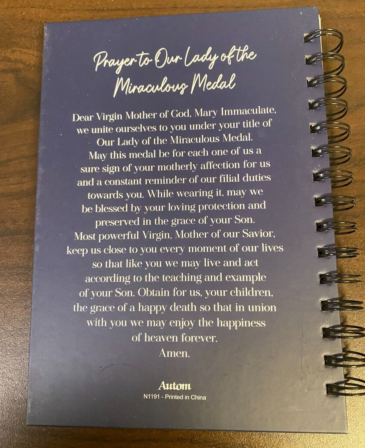 Hardcover journal featuring Our Lady of the Miraculous Medal design, from Bob and Penny Lord, with religious statue imagery.