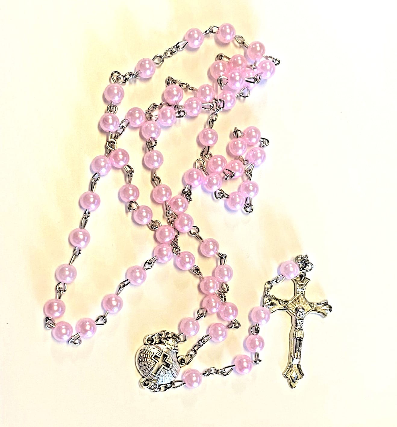 Pink rosary with beads and crucifix, Christian religious collectible from Journeys of Faith, used for baptism or prayer.