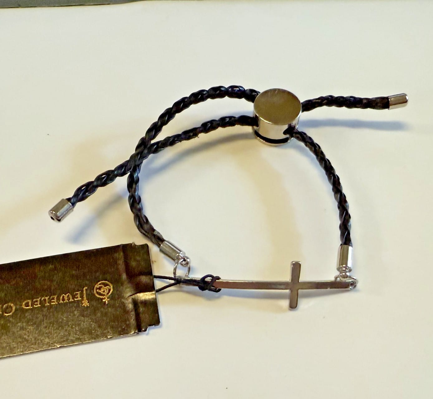 Silver tone Cross bracelet with adjustable cord from Journeys of Faith, featuring a Christian jewelry design.