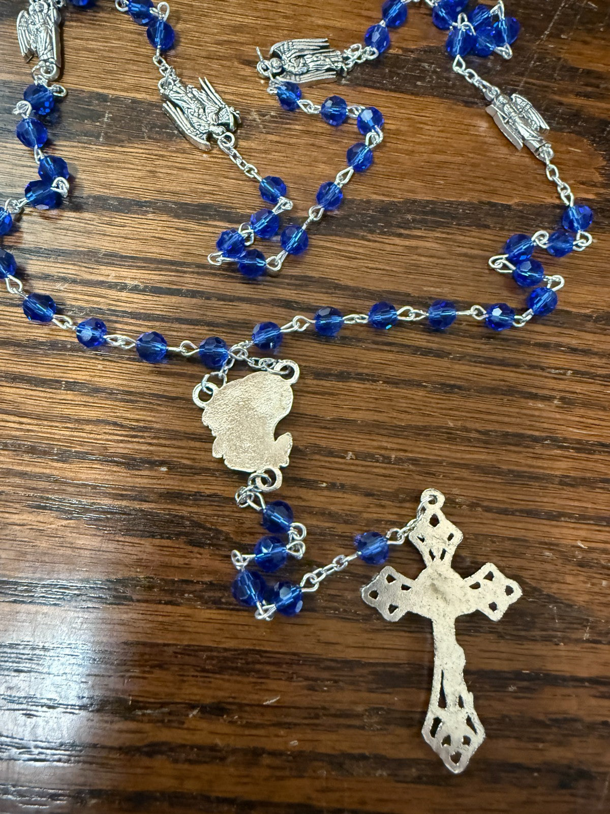 Blue glass beads rosary featuring Saint Michael and archangels, with metallic medals, designed for Christian devotional use.