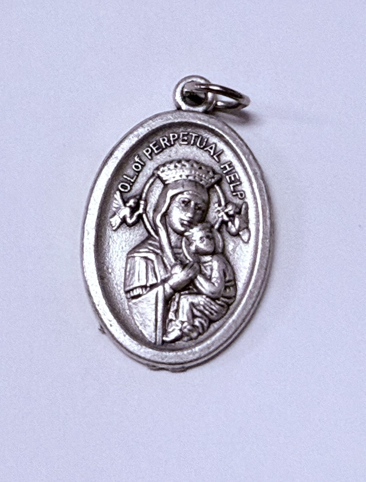 Silver tone Our Lady of Perpetual Help medal by Bob and Penny Lord, Christian religious collectible featuring the Virgin Mary image.