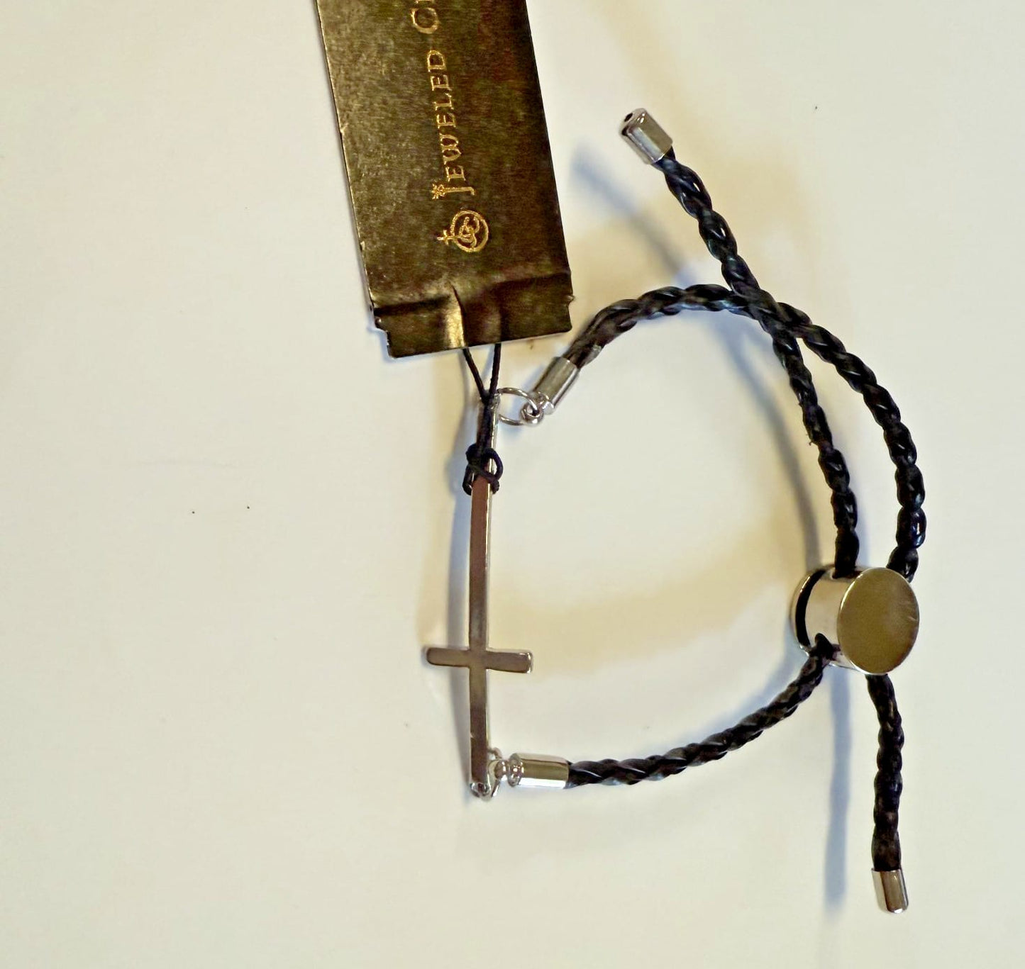 Silver-tone Cross bracelet with adjustable cord, Christian jewelry by Journeys of Faith, featuring a detailed cross design.