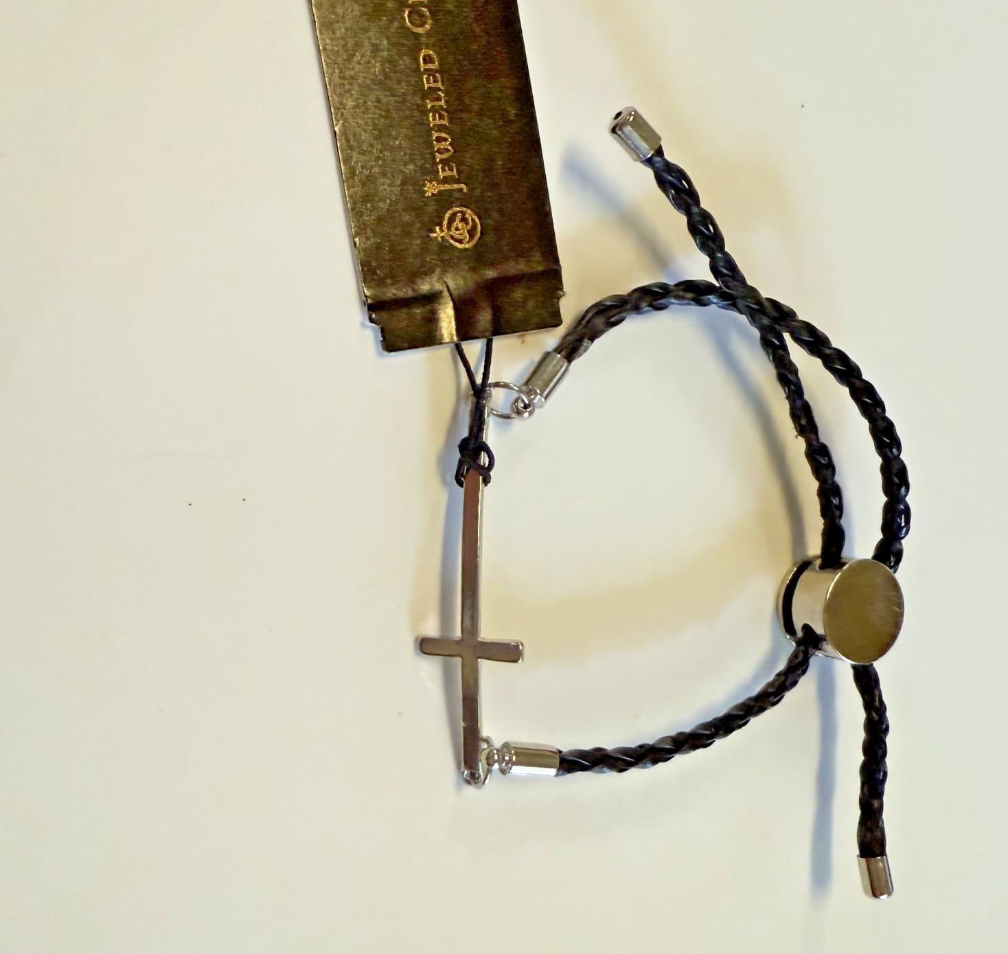 Silver-tone Cross bracelet with adjustable cord, Christian jewelry by Journeys of Faith, featuring a detailed cross design.