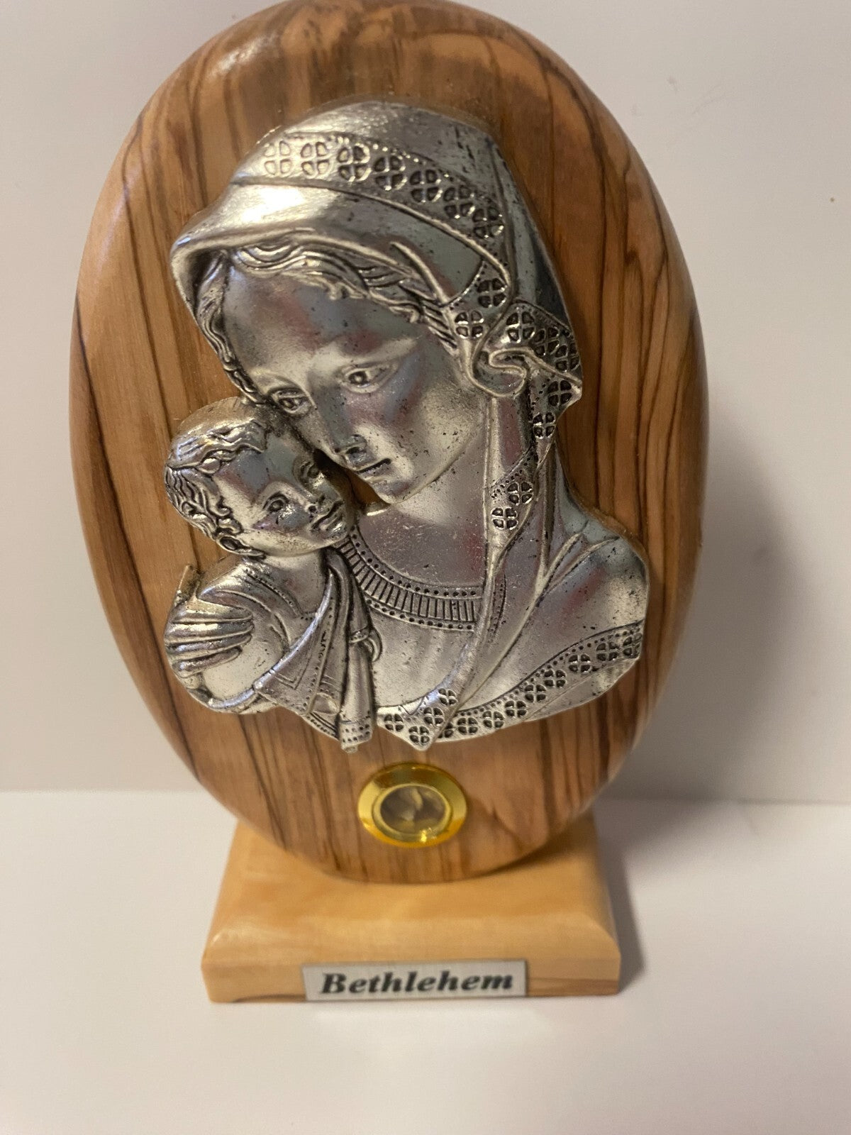 Pewter religious art depicting a mother with child, mounted on wood plaque, part of Christian collectibles by Bob and Penny Lord.