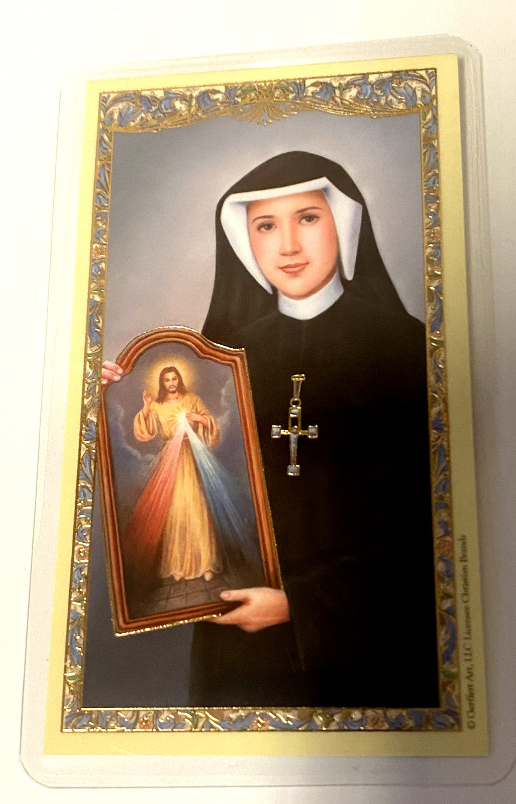 Saint Sister Faustina laminated prayer card from Bob and Penny Lord, featuring religious imagery and prayer text.