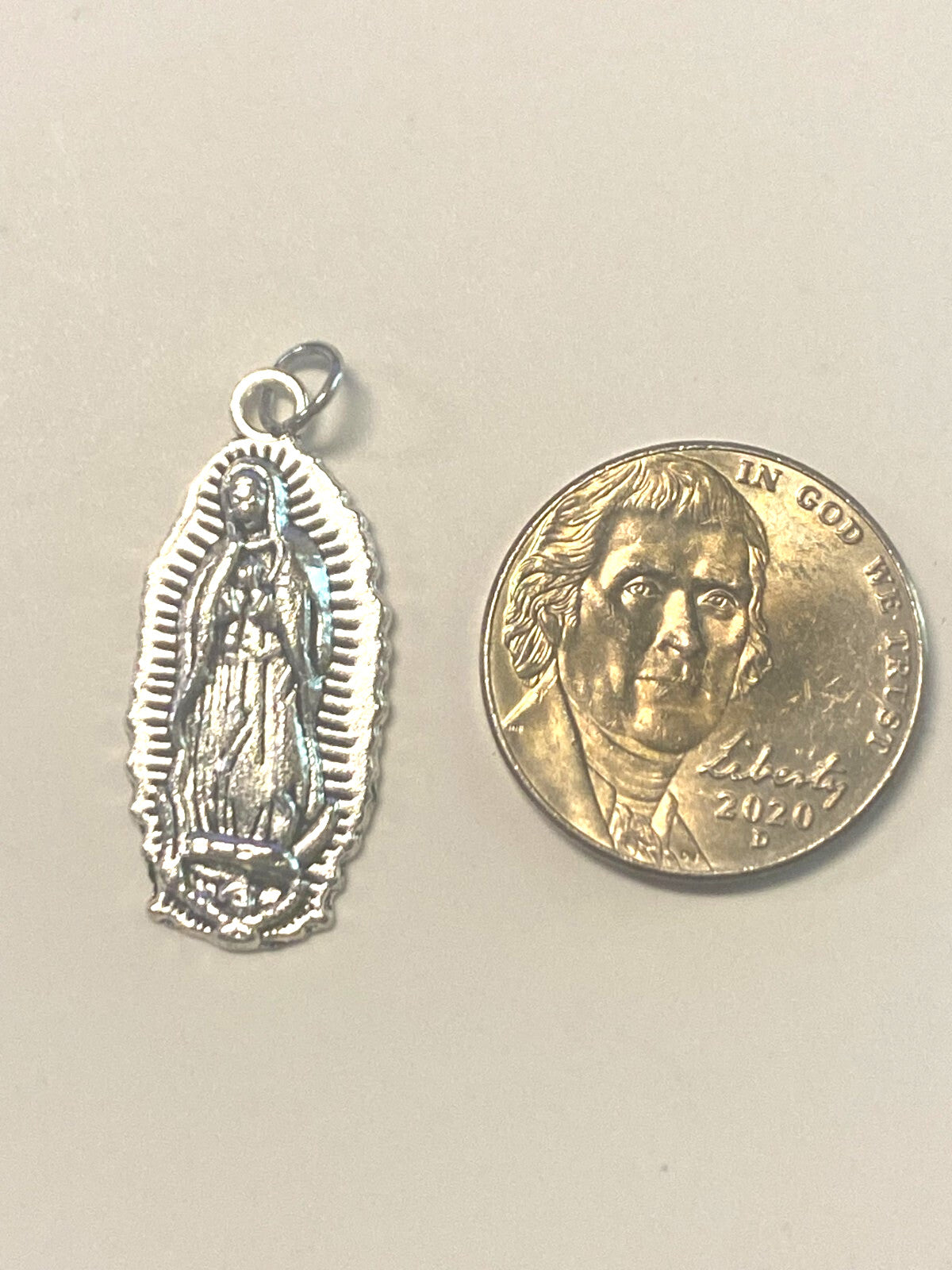 Silver plated Our Lady of Guadalupe medal, 1-inch size, featuring religious Christian imagery, by Bob and Penny Lord.