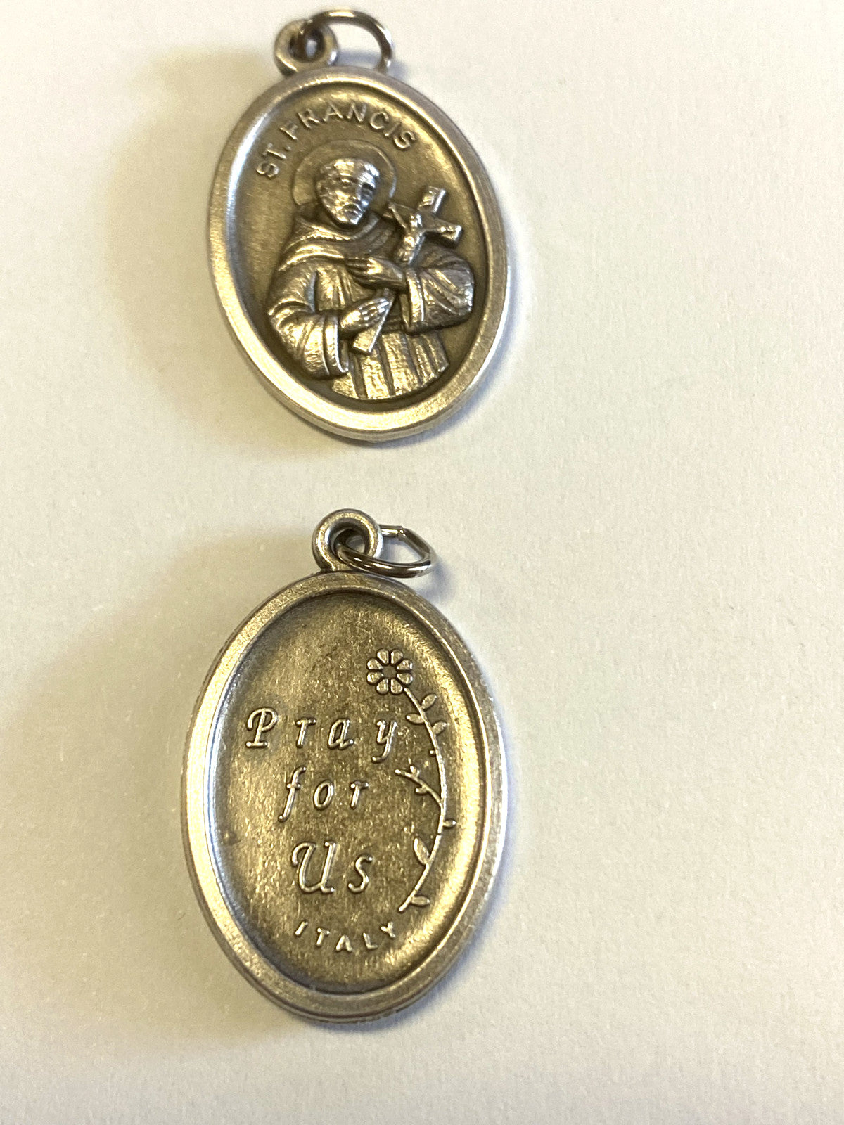 Silver tone Saint Francis of Assisi medal from Italy, Christian religious collectible with detailed religious imagery.