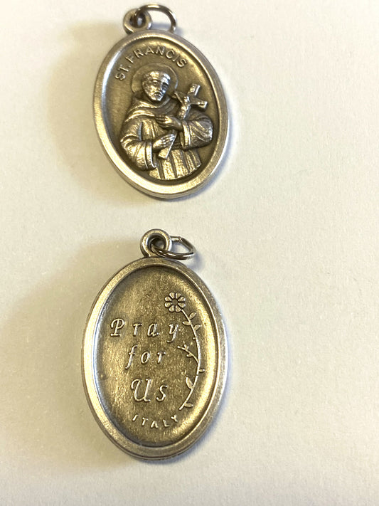 Silver tone Saint Francis of Assisi medal from Italy, Christian religious collectible with detailed religious imagery.