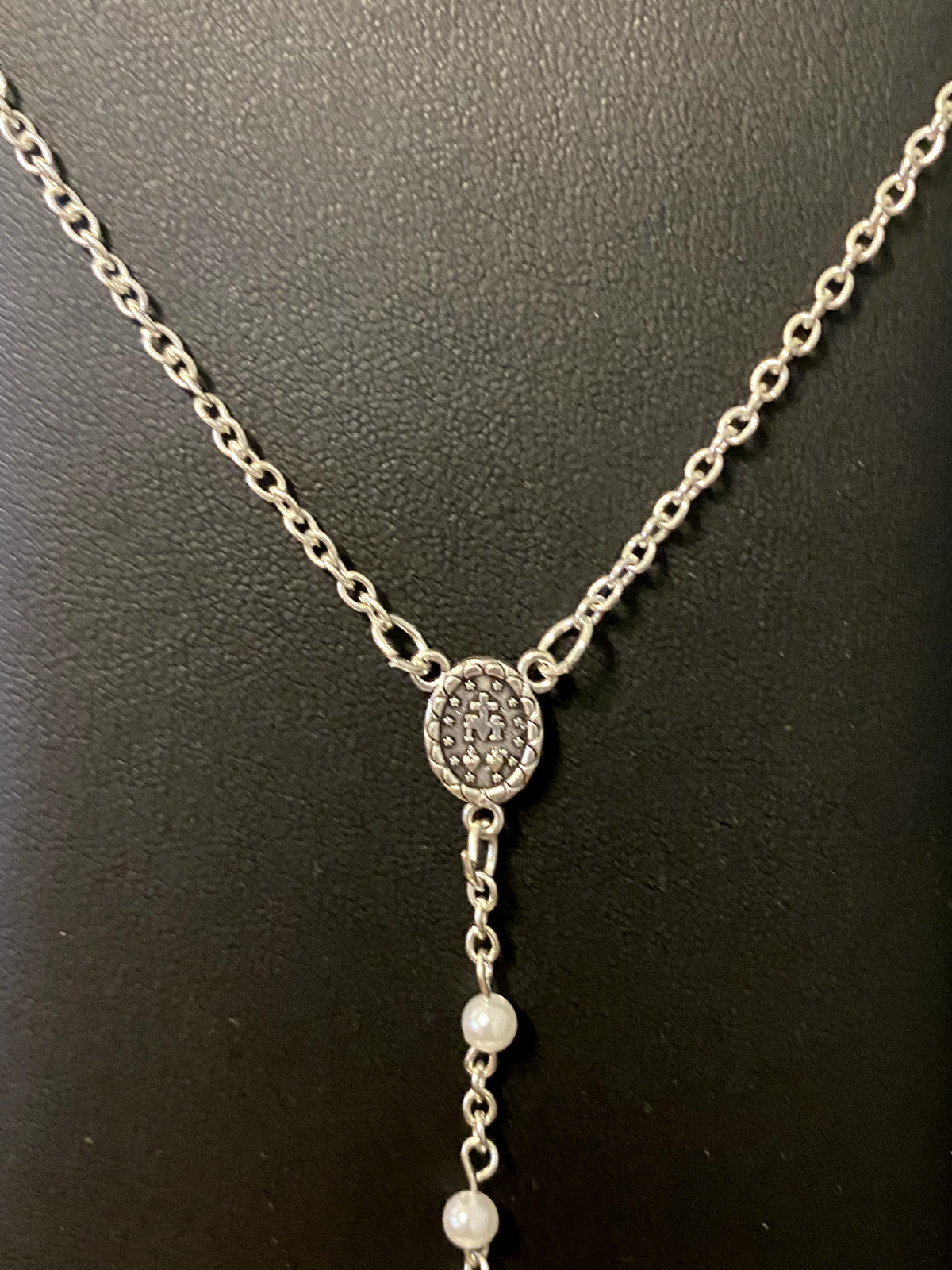 White faux pearl rosary necklace, 18 inches long, with silver-tone accents, from Bob and Penny Lord, used for religious prayer and devotion.